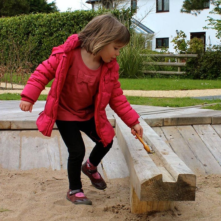 Girl Playing in Sand Pit